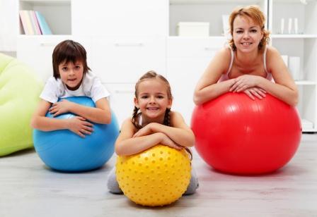 Happy healthy family relaxing in the middle of gymnastic exercise